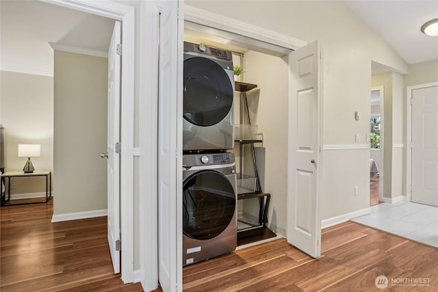 13145 102nd Ln NE Unit 6, Kirkland, WA 98034 - laundry area featuring stacked washer / drying machine, wood finished floors, and crown molding