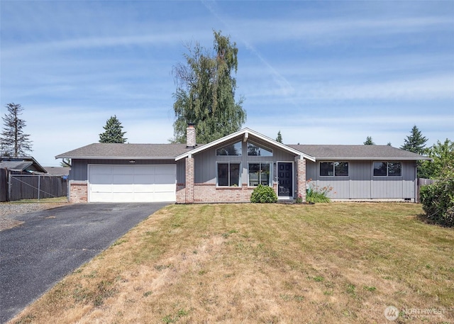 9610 Belmont Dr, Everett, WA 98208 - view of front facade featuring driveway, brick siding, an attached garage, and a chimney