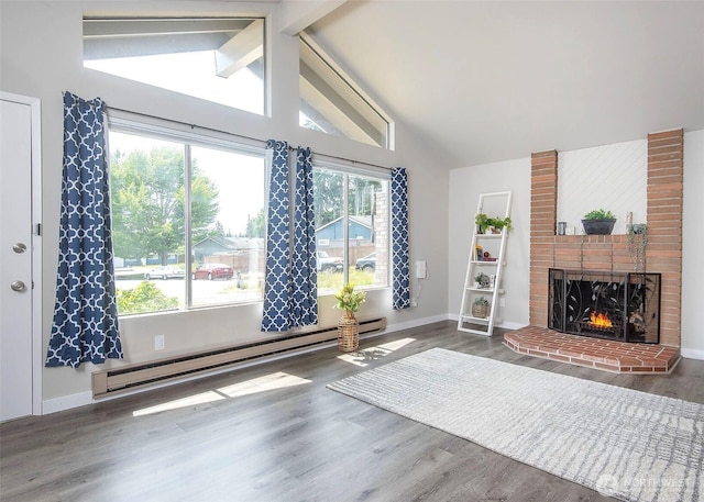 9610 Belmont Dr, Everett, WA 98208 - living area featuring a baseboard heating unit, wood finished floors, and a fireplace