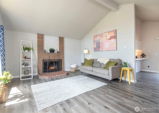 9610 Belmont Dr, Everett, WA 98208 - living area featuring wood finished floors, a fireplace, beam ceiling, and high vaulted ceiling