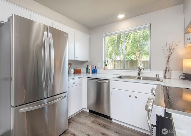 9610 Belmont Dr, Everett, WA 98208 - kitchen with stainless steel appliances, white cabinetry, light countertops, light wood-style flooring, and recessed lighting