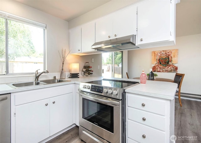 9610 Belmont Dr, Everett, WA 98208 - kitchen with stainless steel appliances, under cabinet range hood, a peninsula, wood finished floors, and light countertops