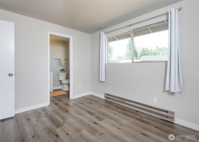9610 Belmont Dr, Everett, WA 98208 - unfurnished bedroom with a baseboard radiator, wood finished floors, and ensuite bathroom