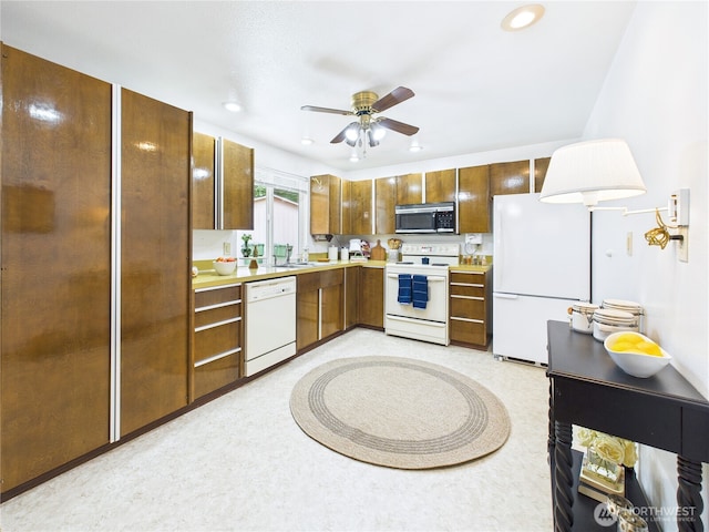 5511 Chokecherry Cir W, University Place, WA 98467 - kitchen with white appliances, light countertops, ceiling fan, recessed lighting, and brown cabinetry