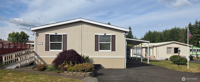 57 Clemons Rd Unit 17, Montesano, WA 98563 - view of front of house featuring an attached carport, entry steps, and driveway