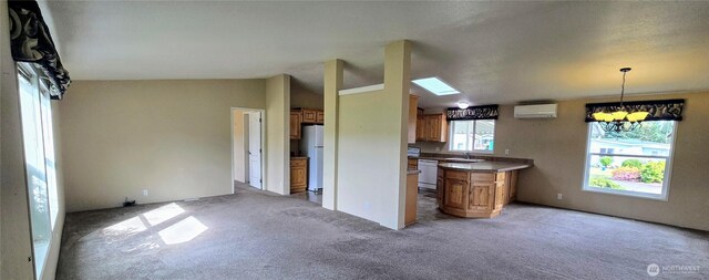 57 Clemons Rd Unit 17, Montesano, WA 98563 - kitchen featuring white appliances, brown cabinets, a chandelier, light carpet, and a wall mounted air conditioner