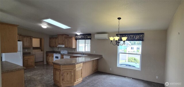 57 Clemons Rd Unit 17, Montesano, WA 98563 - kitchen with white appliances, under cabinet range hood, washer / clothes dryer, a chandelier, and a wall mounted air conditioner