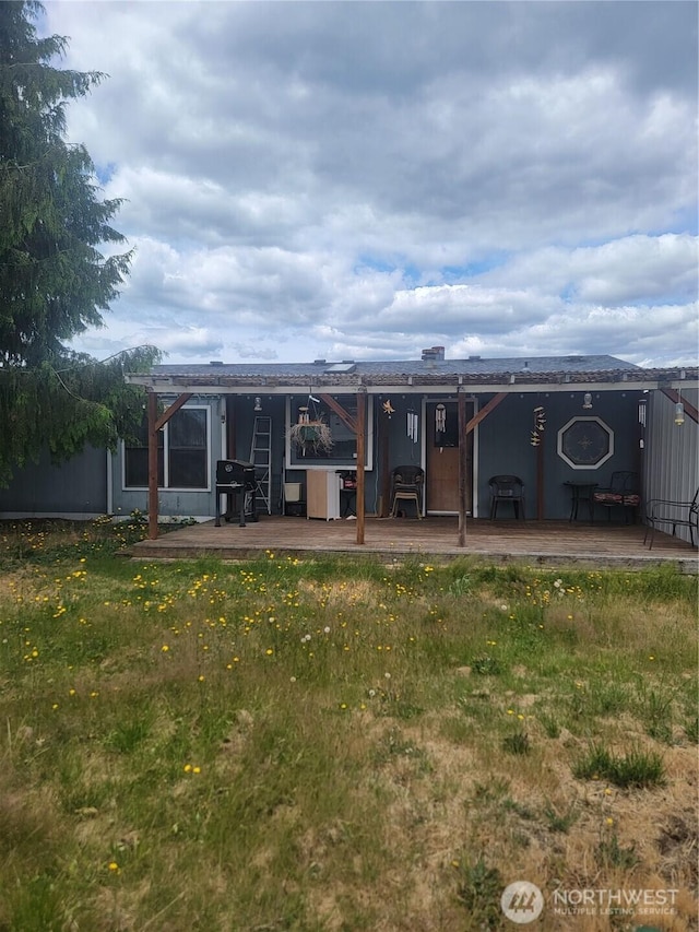 1502 Yelm Ave W Unit 7, Yelm, WA 98597 - back of house with a wooden deck and a lawn