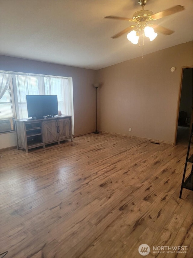 1502 Yelm Ave W Unit 7, Yelm, WA 98597 - unfurnished living room with wood finished floors and ceiling fan