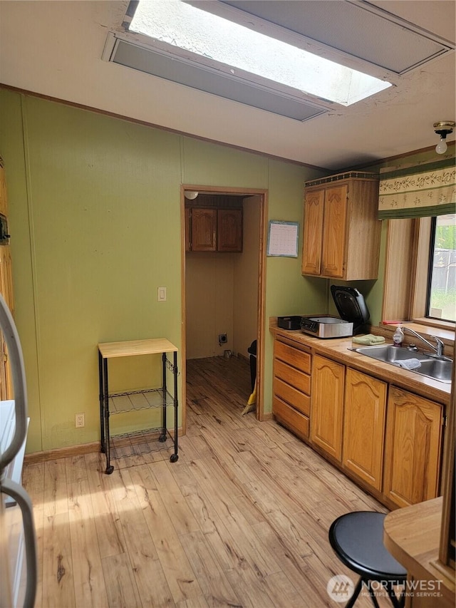 1502 Yelm Ave W Unit 7, Yelm, WA 98597 - kitchen featuring light wood finished floors, brown cabinetry, and a skylight