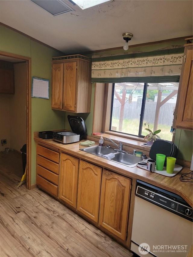 1502 Yelm Ave W Unit 7, Yelm, WA 98597 - kitchen featuring white dishwasher, light wood-style flooring, brown cabinetry, light countertops, and lofted ceiling