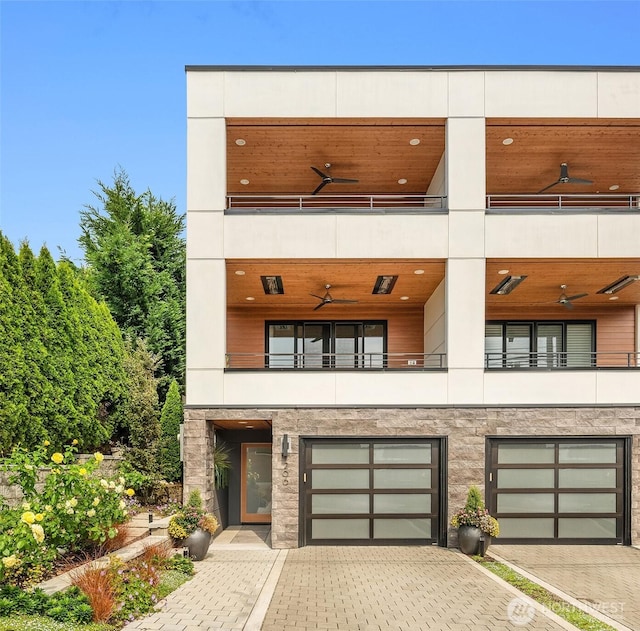 206 5th Ave, Kirkland, WA 98033 - view of front of property featuring a balcony, driveway, an attached garage, and ceiling fan