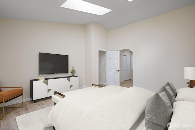 2021 224th Pl NE, Sammamish, WA 98074 - bedroom featuring lofted ceiling, a skylight, and light wood-style flooring
