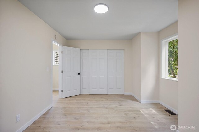 2021 224th Pl NE, Sammamish, WA 98074 - unfurnished bedroom featuring light wood-style flooring and a closet
