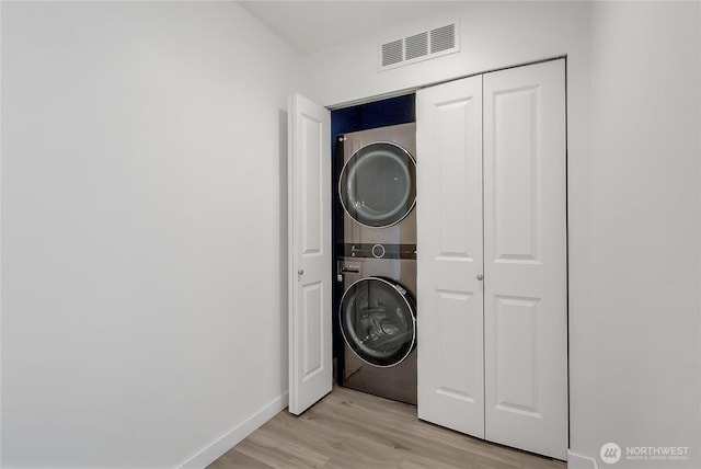 990 43rd Ct NE, Auburn, WA 98002 - washroom featuring stacked washing machine and dryer and light wood-style flooring