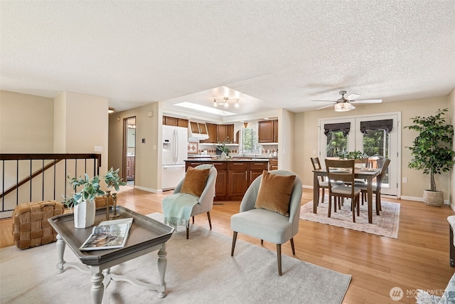 8524 46th Ct NE, Olympia, WA 98516 - living room featuring a textured ceiling, ceiling fan, and light wood finished floors