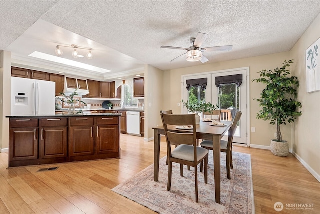 8524 46th Ct NE, Olympia, WA 98516 - dining space with light wood-type flooring, a textured ceiling, a ceiling fan, and plenty of natural light