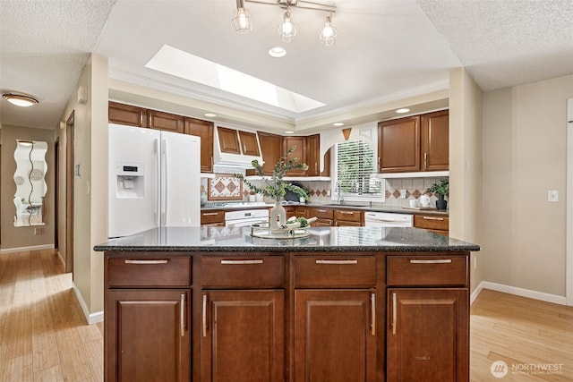 8524 46th Ct NE, Olympia, WA 98516 - kitchen with white appliances, light wood finished floors, backsplash, a textured ceiling, and a skylight