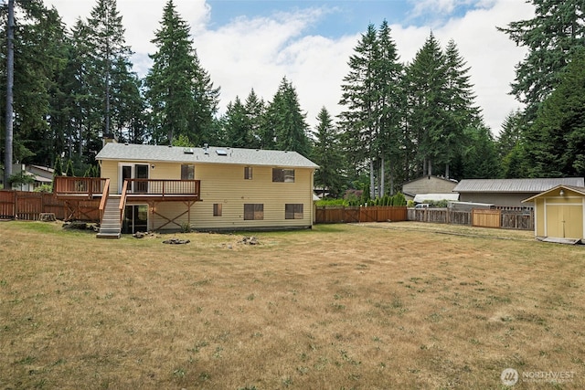 8524 46th Ct NE, Olympia, WA 98516 - back of property with a deck, a shed, a fenced backyard, a chimney, and stairs