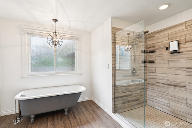 611 Elizabeth St, Sumner, WA 98390 - bathroom with a chandelier, a stall shower, wood finished floors, and a freestanding tub