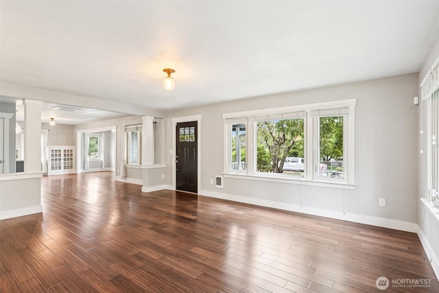 611 Elizabeth St, Sumner, WA 98390 - unfurnished living room with wood finished floors and ornate columns