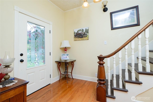 603 W 1st St, Nooksack, WA 98276 - foyer entrance with crown molding, light wood-style flooring, and stairs
