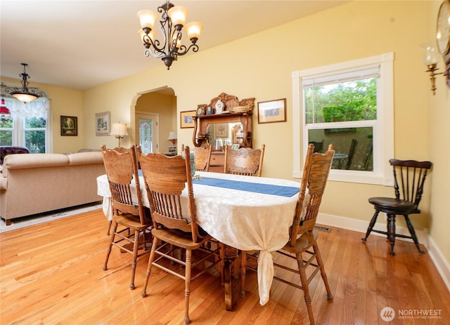 603 W 1st St, Nooksack, WA 98276 - dining room with arched walkways, wood finished floors, and a chandelier