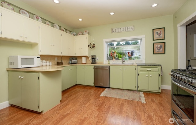 603 W 1st St, Nooksack, WA 98276 - kitchen with stainless steel appliances, light wood-style flooring, green cabinetry, recessed lighting, and light countertops