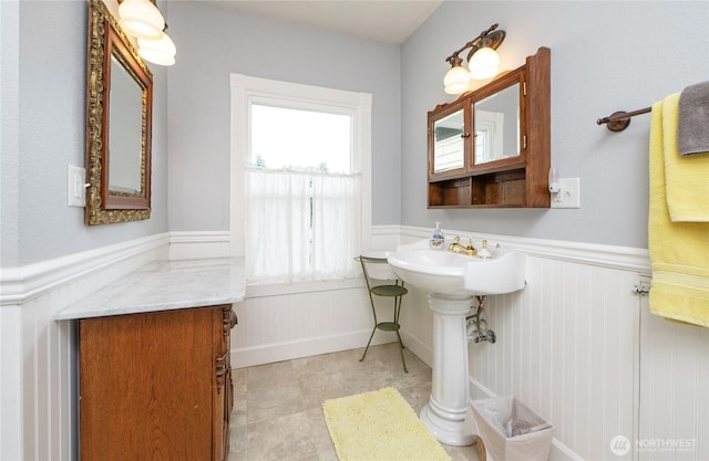 603 W 1st St, Nooksack, WA 98276 - bathroom with wainscoting and a decorative wall