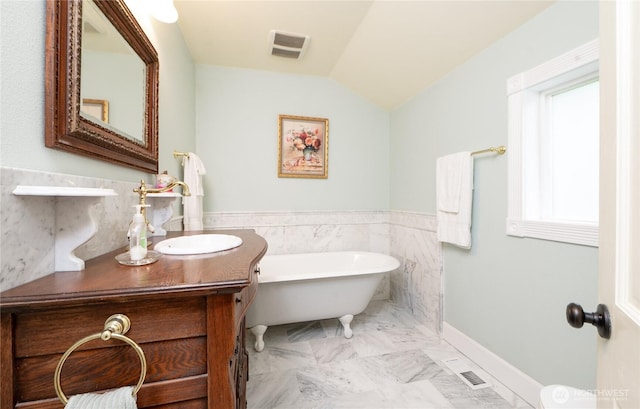 603 W 1st St, Nooksack, WA 98276 - bathroom with a freestanding bath, vanity, marble look tiles, and lofted ceiling