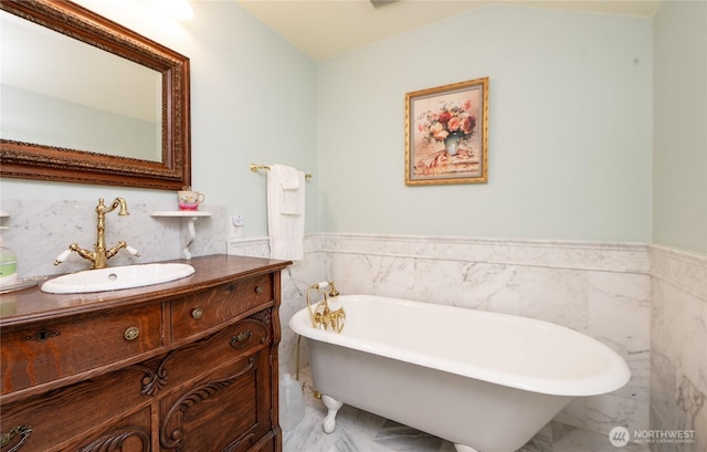 603 W 1st St, Nooksack, WA 98276 - bathroom with marble finish floors, vanity, wainscoting, tile walls, and a freestanding bath