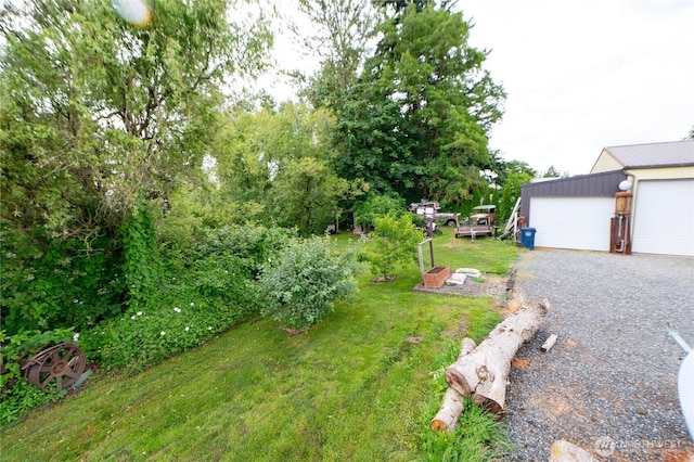 603 W 1st St, Nooksack, WA 98276 - view of green lawn with a detached garage and an outbuilding