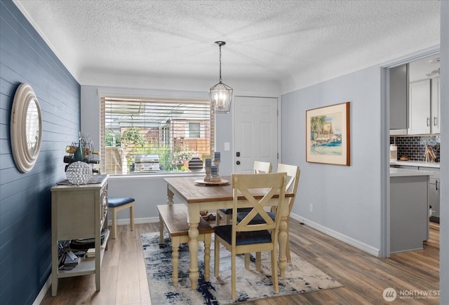 1501 52nd St SE Unit 1, Everett, WA 98203 - dining area featuring a textured ceiling, wood finished floors, and a chandelier