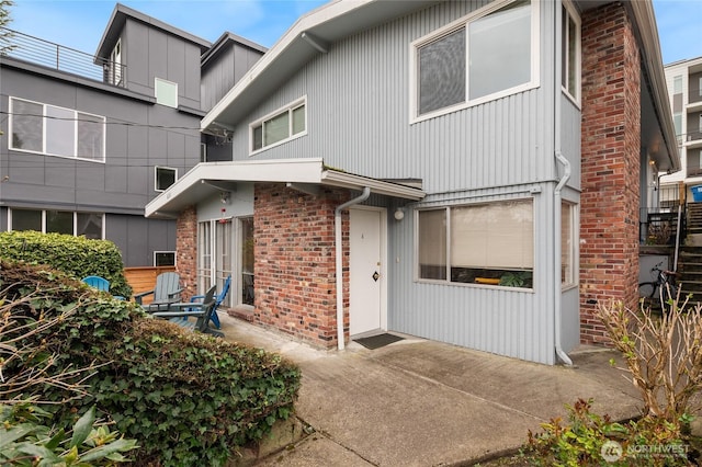 633 W Emerson St, Seattle, WA 98119 - view of front facade with a patio area and brick siding