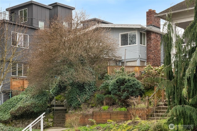 633 W Emerson St, Seattle, WA 98119 - view of home's exterior featuring stairs and a chimney