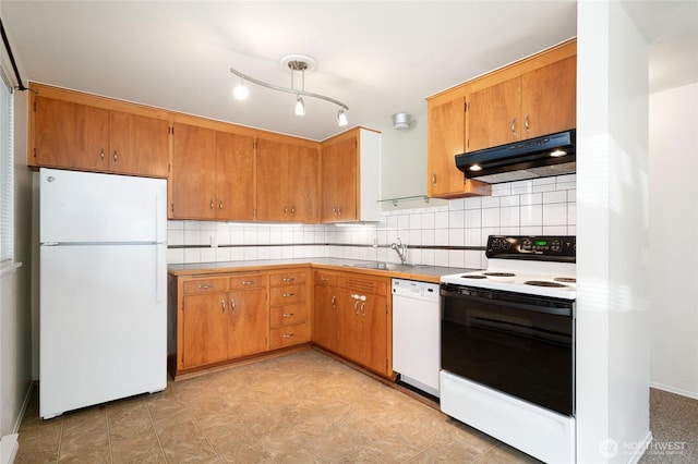 633 W Emerson St, Seattle, WA 98119 - kitchen with white appliances, under cabinet range hood, decorative backsplash, light countertops, and brown cabinets