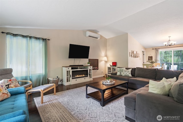 130 Kimberlund Ln, Chehalis, WA 98532 - living area with a wall mounted air conditioner, lofted ceiling, a chandelier, wood finished floors, and a glass covered fireplace