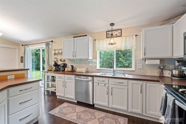 130 Kimberlund Ln, Chehalis, WA 98532 - kitchen with appliances with stainless steel finishes, tasteful backsplash, white cabinetry, hanging light fixtures, and dark wood finished floors