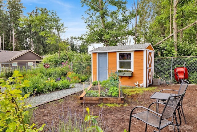 2610 E Section St Unit 25, Mount Vernon, WA 98274 - view of shed with a garden, a fenced backyard, and view of wooded area