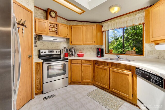 1427 100th St SW Unit 160, Everett, WA 98204 - kitchen with appliances with stainless steel finishes, under cabinet range hood, light flooring, light countertops, and ornamental molding