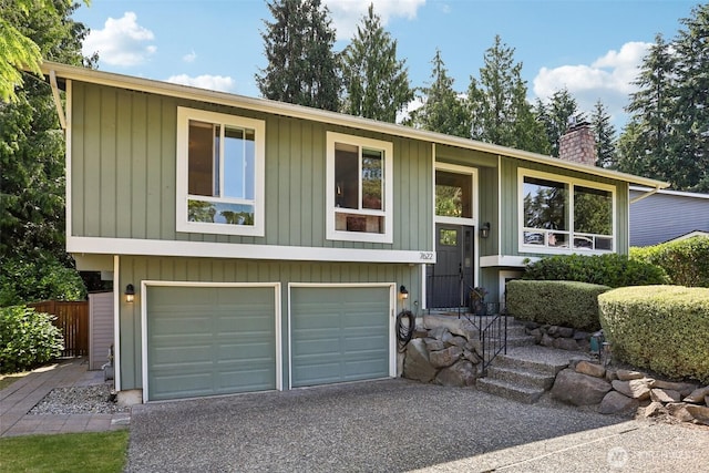 7622 130th Ave NE, Kirkland, WA 98033 - split foyer home with a chimney, a garage, and driveway