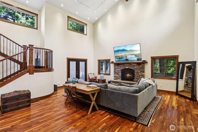 7622 130th Ave NE, Kirkland, WA 98033 - living area featuring stairs, hardwood / wood-style floors, a towering ceiling, healthy amount of natural light, and recessed lighting