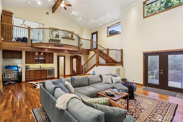 7622 130th Ave NE, Kirkland, WA 98033 - living room with high vaulted ceiling, dark wood-style flooring, a ceiling fan, stairs, and french doors