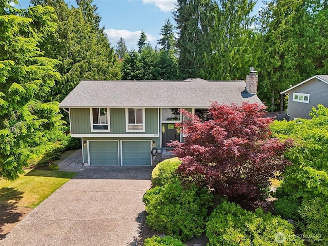 7622 130th Ave NE, Kirkland, WA 98033 - raised ranch with concrete driveway, a garage, a shingled roof, and a chimney