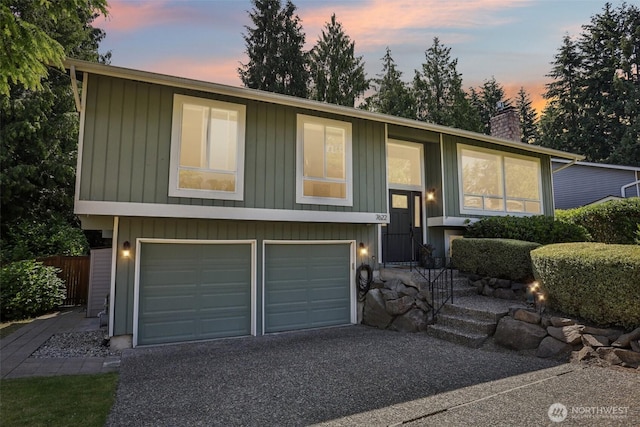 7622 130th Ave NE, Kirkland, WA 98033 - split foyer home with a chimney, driveway, and a garage