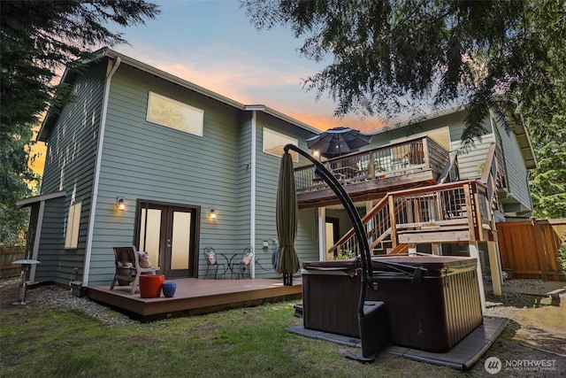 7622 130th Ave NE, Kirkland, WA 98033 - back of property at dusk featuring a hot tub and a deck