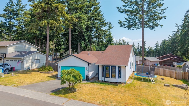 538 NW Ensign Dr, Oak Harbor, WA 98277 - view of front of property featuring asphalt driveway, a garage, a trampoline, and a shingled roof