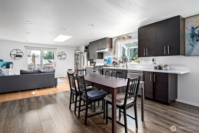 538 NW Ensign Dr, Oak Harbor, WA 98277 - dining room featuring dark wood-style flooring, healthy amount of natural light, a skylight, and recessed lighting