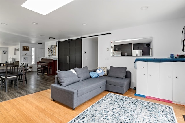 538 NW Ensign Dr, Oak Harbor, WA 98277 - living area with a barn door, wood finished floors, and recessed lighting