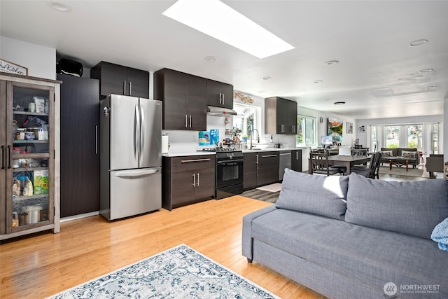 538 NW Ensign Dr, Oak Harbor, WA 98277 - kitchen featuring appliances with stainless steel finishes, light countertops, light wood-type flooring, a skylight, and recessed lighting